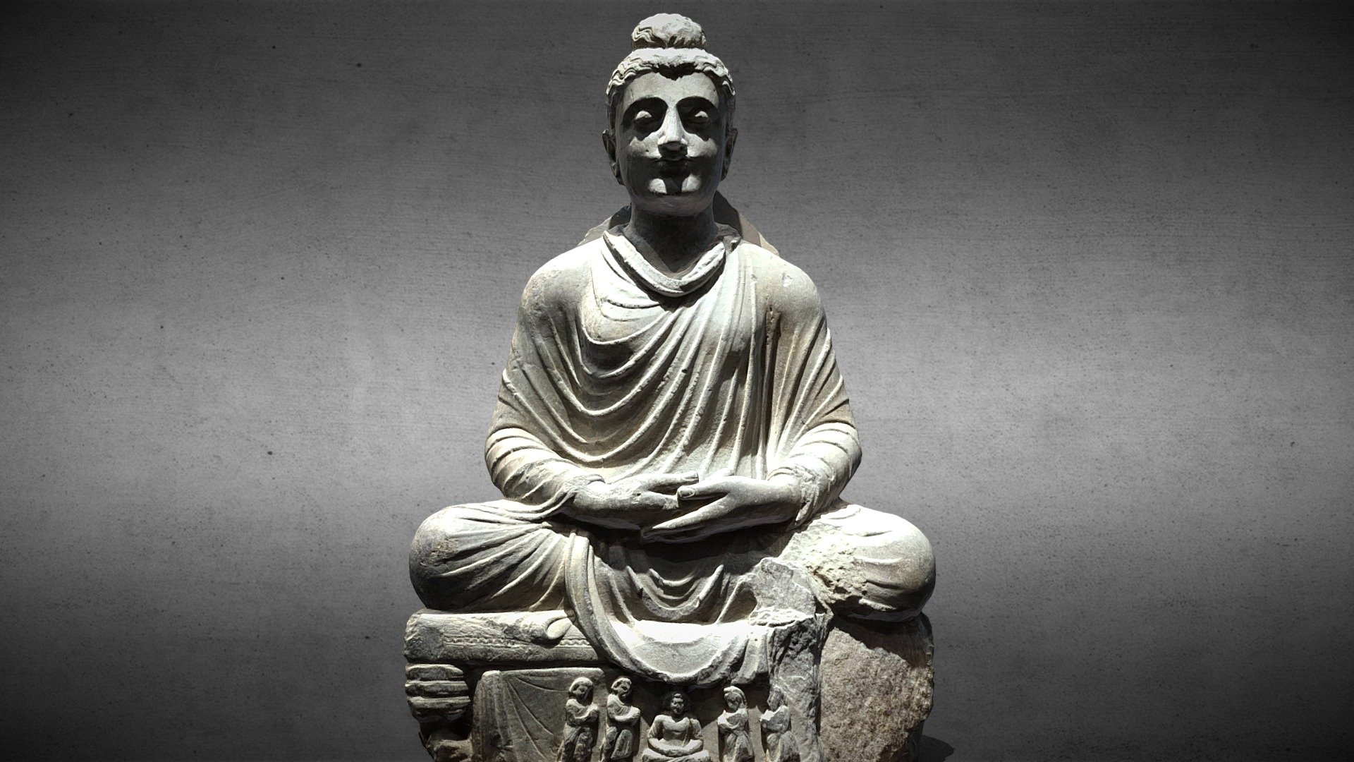 Second century AD, schist, Salibaro area
This seated Buddha statue is from the Salibaro area. The overall craftsmanship of the Buddha statue is exquisite, large in size, and well preserved. The Buddha's backlight is missing, and the hairline is evenly arranged in a wavy shape to the knotted bun on the top of the head, with smooth and natural lines.（净慈美术馆）