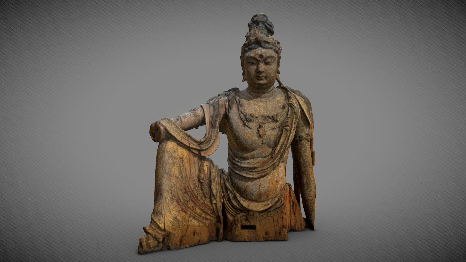 Bodhisattva, Shanxi Province, Jin Dynasty, circa 1200, wood, traces of gold and polychrome. Musée d'Art et d'Histoire (Musée du Cinquantenaire, Brussels, Belgium). Made with Zephyr3D Lite from 3DFlow.

The Bodhisattva is the central figure of Mahayana Buddhism. He has attained a high spiritual level but he differs his enlightenment to help other men on the spiritual path.
Here we see a representation of Guanyin (Avalokitesvara in Sanskrit), the bodhisattva of compassion. While in India, this bodhisattva is still depicted as a man, in regions further east of Asia he looks like an androgynous, even a woman. Unlike the soberly dressed Buddha, bodhisattvas often wear royal garments, ornaments, crowns and other jewels. This work shows a remarkable necklace enhanced with two entangled dragons.
The attitude represented is that of the &ldquo;royal relaxation