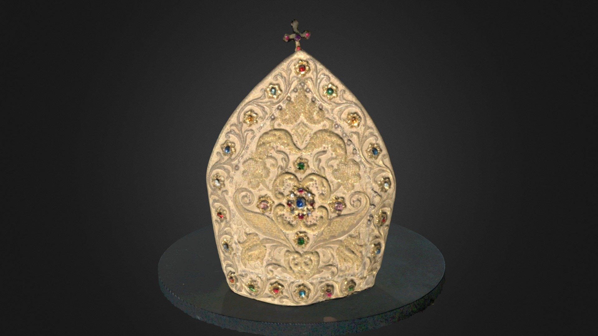 A mitre is a bishop or abbot’s distinctive ceremonial head-dress. This mitre is hand embroidered and is set with semi-precious and non-precious stones.  This mitre came from St James Abbey, Ratisbon (now Regensburg), Germany.
After the abbey closed, the mitre went with the last of the Scottish monks to the new abbey they founded at Fort Augustus in 1862.  This object belongs to the Scottish Catholic Heritage Collections Trust, T6227aBLRBM - Ratisbon Mitre, Blairs Museum, Aberdeen - 3D model by orbitalscot 3d model