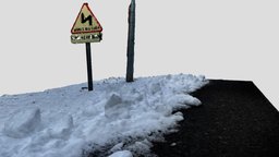 Turn warning road sign in the snow