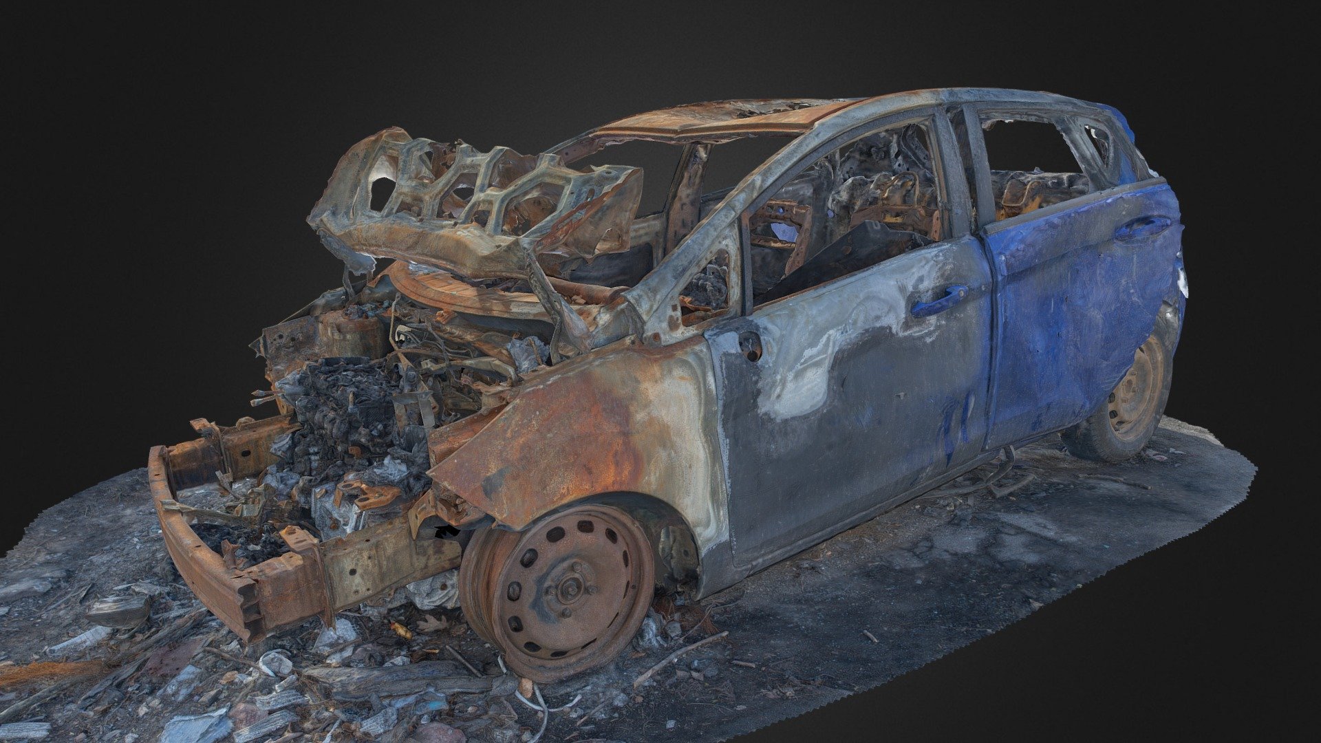 3D scan of a burned blue car. 
Front completely destroyed, back part somewhat intact. 
With normal map 3d model
