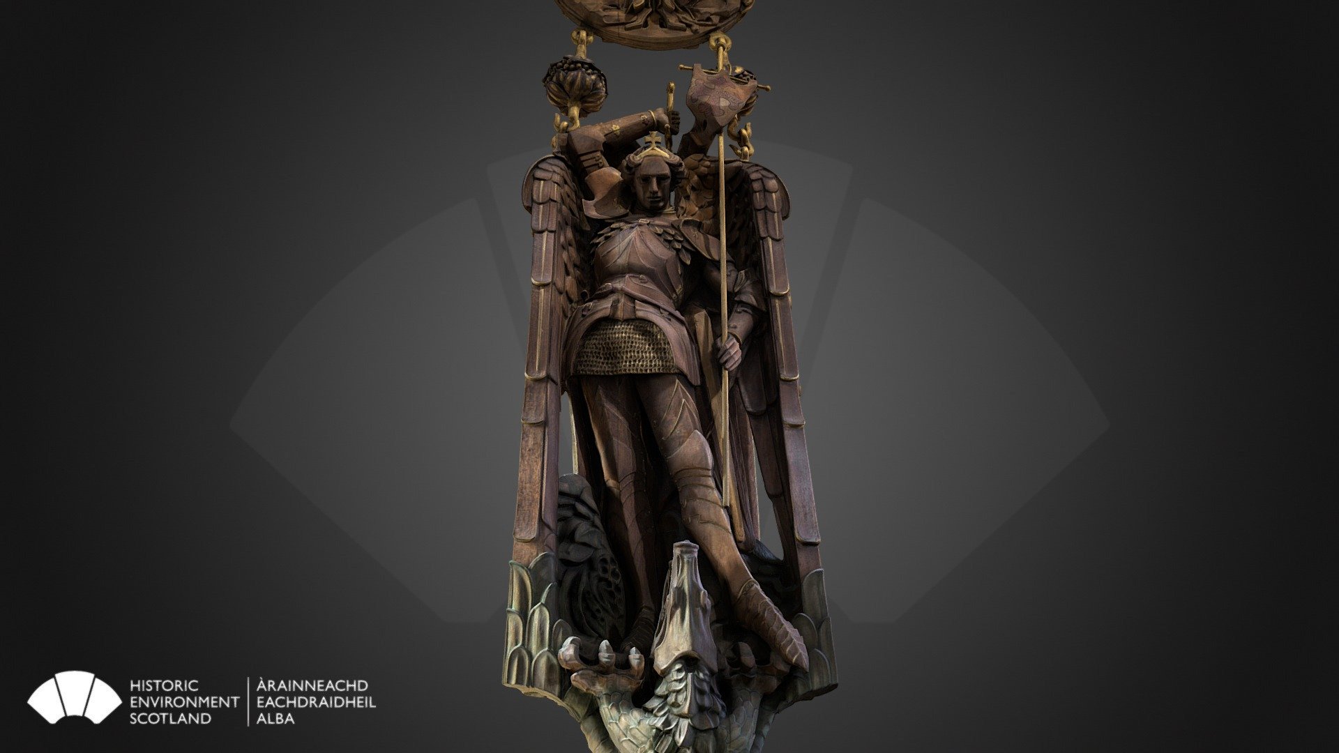 This timber carving of the archangel St Michael stands at 3.3 metres tall, with its large medallion engraved with a cross coming in at 5.4 meters and is suspended from the vaulted ceiling on the Scottish National War Memorial 9.3 metres above the casket that holds the Roll of Honour of the Scottish War Dead. 

The carving is made of Scottish Oak and was made by the Clow brothers from a design by Alice Meredith-Williams. 

The Scottish War Memorial opened in 1927 after the former North Barracks were altered. It is located at the North side of Crown Square, at the site of the church of St Mary, previously used as munitions store in the 1530s. 

It is cared for on behalf of the nation by a charity that is administered by a board of trustees. To learn more about it head over to our website 3d model