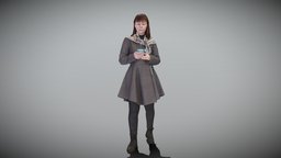 Woman in coat using smartphone 428
